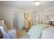 Bright bedroom with ensuite bathroom, neutral carpet, accent chair and decorative dresser at 2000 Old Dominion Rd, Atlanta, GA 30350