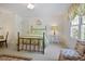 Cozy bedroom featuring a brass bed, bright windows, and a patterned accent chair at 2000 Old Dominion Rd, Atlanta, GA 30350