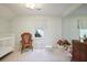Charming bedroom featuring wallpaper, a crib, and vintage furniture at 2000 Old Dominion Rd, Atlanta, GA 30350