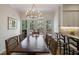 Elegant dining room with a wooden table, large windows, and stylish chandelier at 2000 Old Dominion Rd, Atlanta, GA 30350