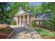 Classic brick home featuring stately columns, a circular driveway, and professionally landscaped grounds at 2000 Old Dominion Rd, Atlanta, GA 30350