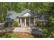 Elegant home featuring a columned front porch and manicured landscaping at 2000 Old Dominion Rd, Atlanta, GA 30350