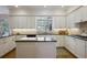 Spacious kitchen featuring white cabinets, dark countertops, an island, and stainless steel appliances at 2000 Old Dominion Rd, Atlanta, GA 30350