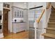 Bright kitchen with hardwood floors, stainless steel refrigerator, stairs, and custom cabinets at 2000 Old Dominion Rd, Atlanta, GA 30350