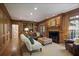 Warm living room featuring wood paneling, built-in bookshelves, and a cozy fireplace at 2000 Old Dominion Rd, Atlanta, GA 30350