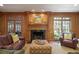 Elegant living room with wood paneling, a fireplace, and comfortable seating at 2000 Old Dominion Rd, Atlanta, GA 30350