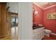 Charming powder room with red wallpaper, and a decorative mirror at 2000 Old Dominion Rd, Atlanta, GA 30350