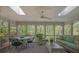 Inviting screened porch featuring a ceiling fan, skylights, comfortable seating, and views of the surrounding woods at 2000 Old Dominion Rd, Atlanta, GA 30350