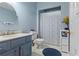 Charming bathroom with blue vanity, and shower-tub combo with patterned curtain at 2518 Oakwood Se Way, Smyrna, GA 30080