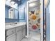 Bathroom features single vanity, mirror, and shower with a fun, space-themed curtain at 2518 Oakwood Se Way, Smyrna, GA 30080