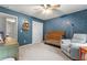 Cozy Bedroom with a crib, a comfortable chair and celestial themed decor at 2518 Oakwood Se Way, Smyrna, GA 30080