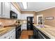 Updated kitchen features stainless steel appliances, granite countertops, and dark cabinetry at 2518 Oakwood Se Way, Smyrna, GA 30080