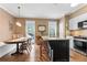 Bright eat-in kitchen featuring stainless steel appliances, granite countertops, and dark wood island at 2518 Oakwood Se Way, Smyrna, GA 30080