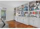 Bright living room featuring a built-in bookcase, hardwood flooring, and elegant trim at 2518 Oakwood Se Way, Smyrna, GA 30080
