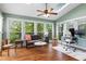 Light-filled sunroom with vaulted ceiling, skylight, hardwood floors, and multiple windows overlooking greenery at 2518 Oakwood Se Way, Smyrna, GA 30080