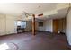 Spacious basement with a vintage ceiling fan, exposed support beam, and natural light from the windows at 3670 Whirlaway Dr, Decatur, GA 30034