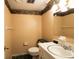 Cozy bathroom featuring a single sink vanity, decorative wallpaper border, and ceramic tile flooring at 3670 Whirlaway Dr, Decatur, GA 30034