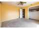 Bedroom featuring a ceiling fan, closet, natural light, carpet flooring, and a yellow wall at 3670 Whirlaway Dr, Decatur, GA 30034
