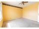 Bright bedroom featuring yellow walls, carpet flooring, and a ceiling fan at 3670 Whirlaway Dr, Decatur, GA 30034