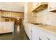 Traditional kitchen with white cabinets and view of the living room with fireplace at 3670 Whirlaway Dr, Decatur, GA 30034