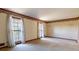 Spacious carpeted living room featuring large windows and patterned trim at 3670 Whirlaway Dr, Decatur, GA 30034