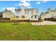 Large backyard with a deck, lawn, and mature trees at 7240 Raintree Loop, Jonesboro, GA 30236