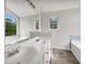 Bright bathroom with double vanity, large tub and window at 7240 Raintree Loop, Jonesboro, GA 30236