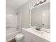 Bathroom featuring a shower-tub combo, a vanity with a sink, and modern lighting at 7240 Raintree Loop, Jonesboro, GA 30236
