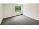 Bedroom with neutral carpeting and a bright window at 7240 Raintree Loop, Jonesboro, GA 30236