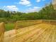 Wide view of backyard from the new wooden deck with light stain and wood railing at 7240 Raintree Loop, Jonesboro, GA 30236