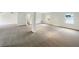 Expansive living room with neutral carpeting and large windows at 7240 Raintree Loop, Jonesboro, GA 30236