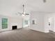 Bright living room with a fireplace, neutral decor, and large windows at 7240 Raintree Loop, Jonesboro, GA 30236