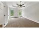 Spacious main bedroom with tray ceiling, ceiling fan, and large windows offering ample light at 7240 Raintree Loop, Jonesboro, GA 30236