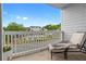 Relaxing balcony area overlooking the community pool, a lounge chair, and seating area at 108 Vinings Forest Se Cir, Smyrna, GA 30080