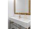 Modern bathroom with a sleek sink, golden fixtures, and a decorative mirror at 108 Vinings Forest Se Cir, Smyrna, GA 30080