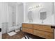 Bright bathroom with double sink vanity, modern lighting, and a combined shower and bathtub at 108 Vinings Forest Se Cir, Smyrna, GA 30080