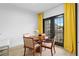Cozy dining area with seating for four, hardwood floors, and French doors with bright yellow curtains at 108 Vinings Forest Se Cir, Smyrna, GA 30080