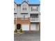 Charming townhome with gray siding, brick accents, and a two-car garage at 108 Vinings Forest Se Cir, Smyrna, GA 30080