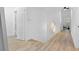 Bright hallway with hardwood floors leading to bedrooms, closet, and other rooms at 108 Vinings Forest Se Cir, Smyrna, GA 30080