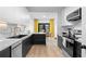 Modern kitchen with white cabinets, stainless steel appliances, and a breakfast nook bathed in natural light at 108 Vinings Forest Se Cir, Smyrna, GA 30080