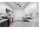 Bright kitchen featuring white cabinets, stainless steel appliances, modern countertops, and hardwood floors at 108 Vinings Forest Se Cir, Smyrna, GA 30080
