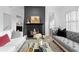 Elegant living room with a cozy fireplace, grey sofa, bright couches, and a glass coffee table at 108 Vinings Forest Se Cir, Smyrna, GA 30080