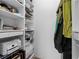 Spacious walk-in closet featuring shelves, wire baskets, and a printer for optimal organization at 108 Vinings Forest Se Cir, Smyrna, GA 30080