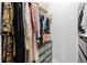 Organized walk-in closet with hanging clothes and drawer storage for a neat, streamlined look at 108 Vinings Forest Se Cir, Smyrna, GA 30080