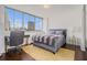 Bedroom featuring a city view, desk area, and modern furnishings, perfect for relaxation and productivity at 215 Piedmont Ne Ave # 1110, Atlanta, GA 30308