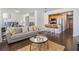 Open-concept living space with modern furniture, island seating, and hardwood floors at 215 Piedmont Ne Ave # 1110, Atlanta, GA 30308