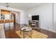 Living room with modern fireplace, plush rug, hardwood flooring, and open kitchen at 215 Piedmont Ne Ave # 1110, Atlanta, GA 30308