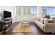 Living room with floor-to-ceiling windows, modern furniture, and fireplace feature at 215 Piedmont Ne Ave # 1110, Atlanta, GA 30308