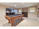 Finished basement with a pool table, bar area with seating, and carpeted floors at 4310 Wellbrook Ct, Douglasville, GA 30135