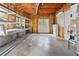 Unfinished basement with metal shelving, double doors, and visible pipes, offering ample storage potential at 4310 Wellbrook Ct, Douglasville, GA 30135